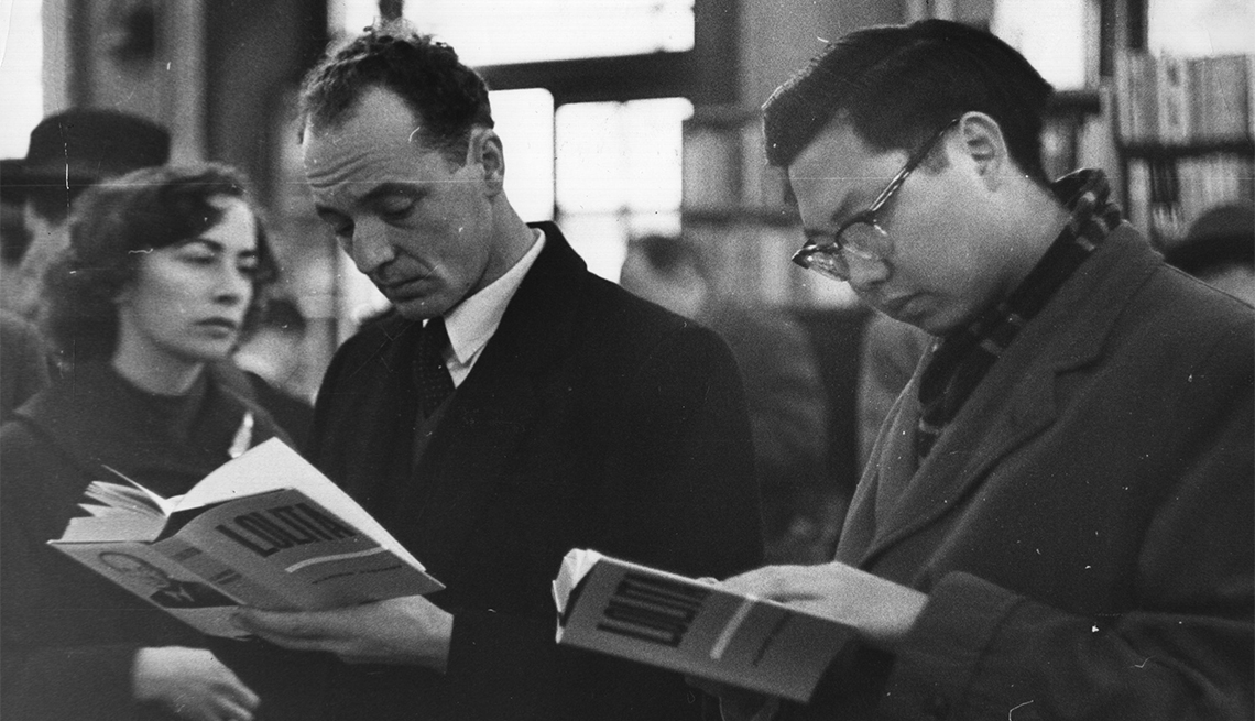 item 14 of Gallery image - Customers at a London bookshop read the controversial bestseller 'Lolita' by Vladimir Nabokov