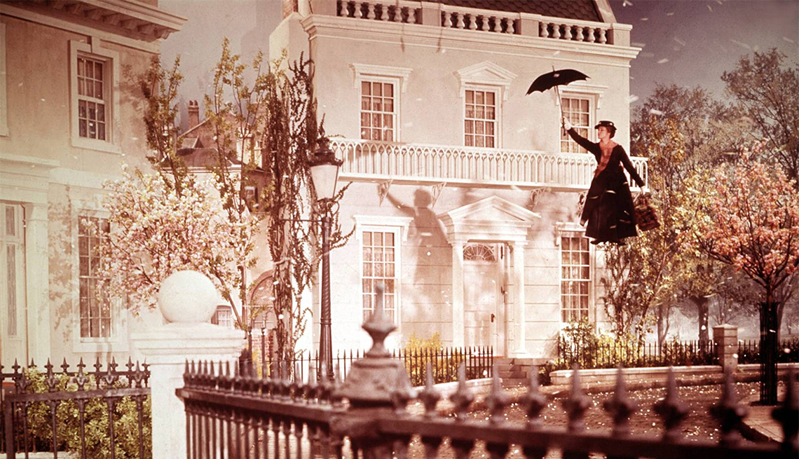 item 5 of Gallery image - Actress Julie Andrews flying in air with umbrella in a still from the movie "Mary Poppins" 