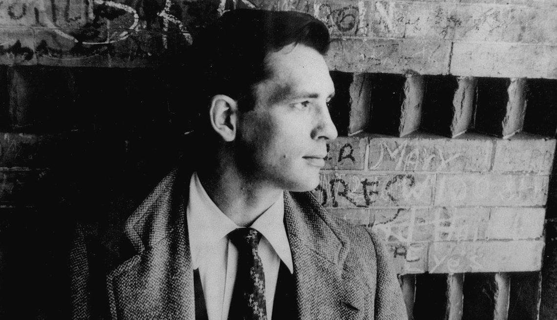 item 26 of Gallery image - Author Jack Kerouac leaning against structure