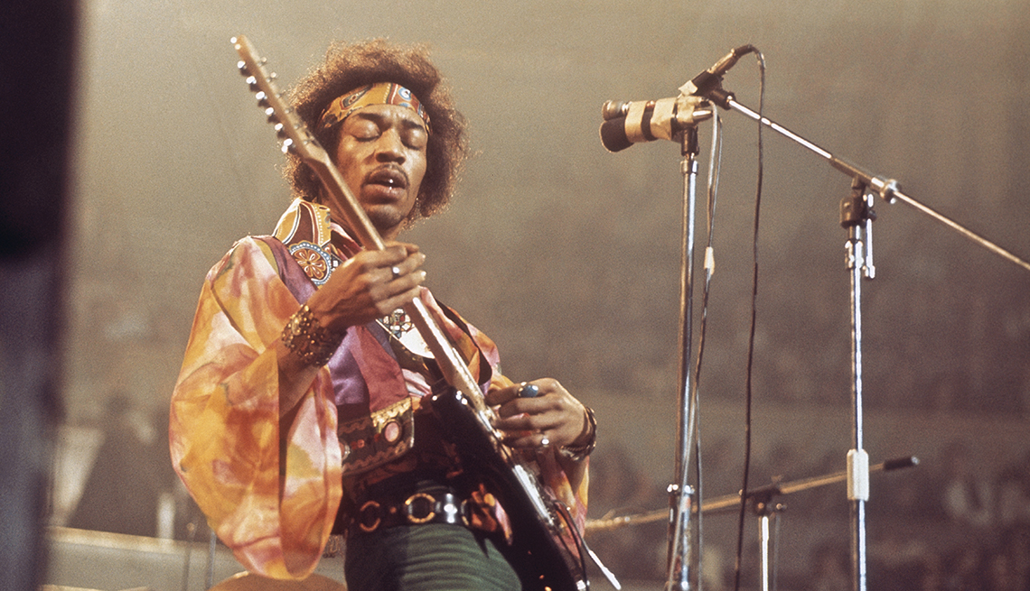 item 13 of Gallery image - American rock guitarist and singer Jimi Hendrix performs live on stage playing a black Fender Stratocaster guitar