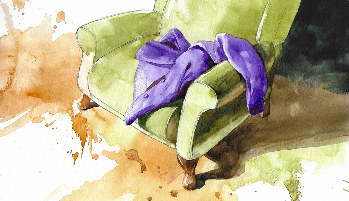 a green armchair with a purple jacket laying on it