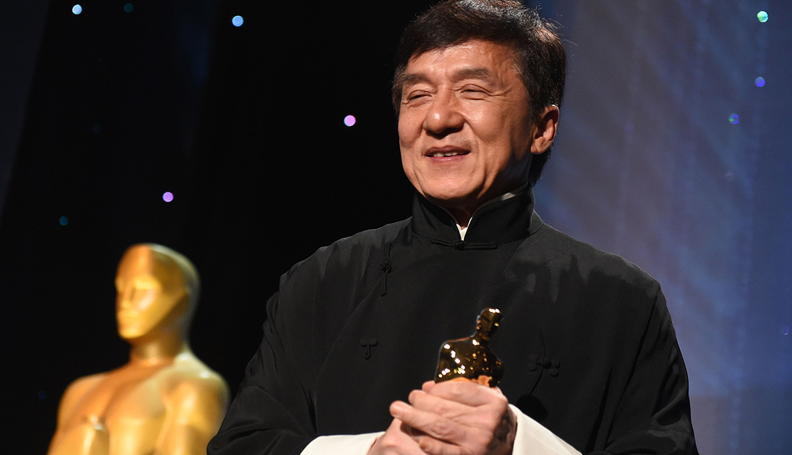 item 19 of Gallery image - Jackie Chan holding honorary Oscar award