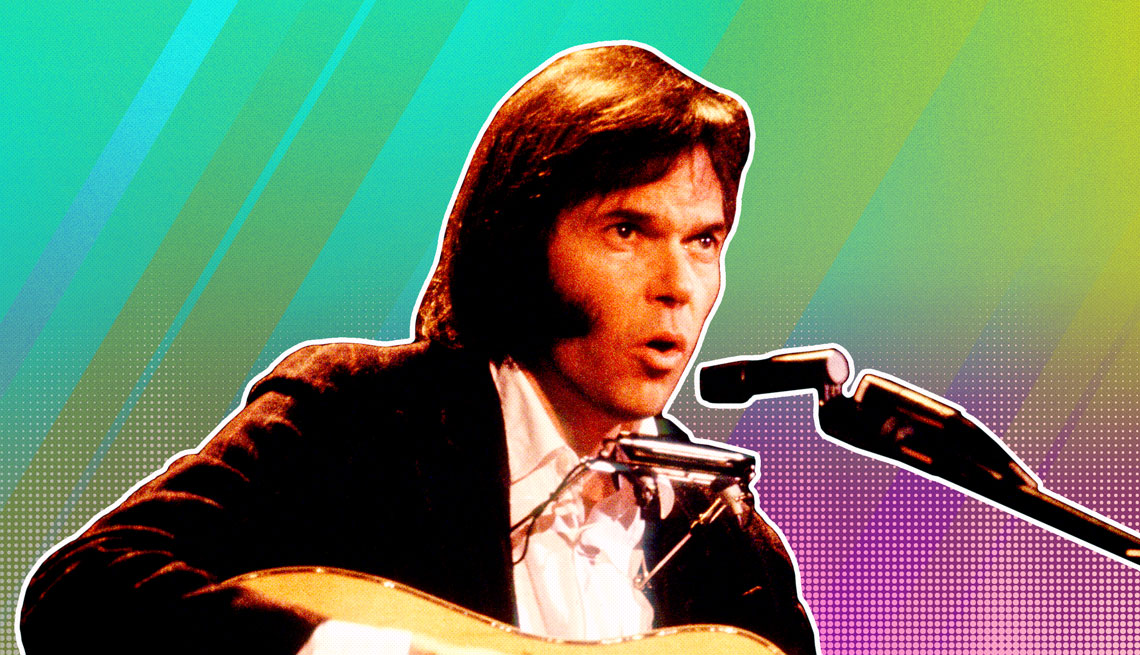 item 19 of Gallery image - Neil Young at a microphone silhouetted against an ombre rainbow background
