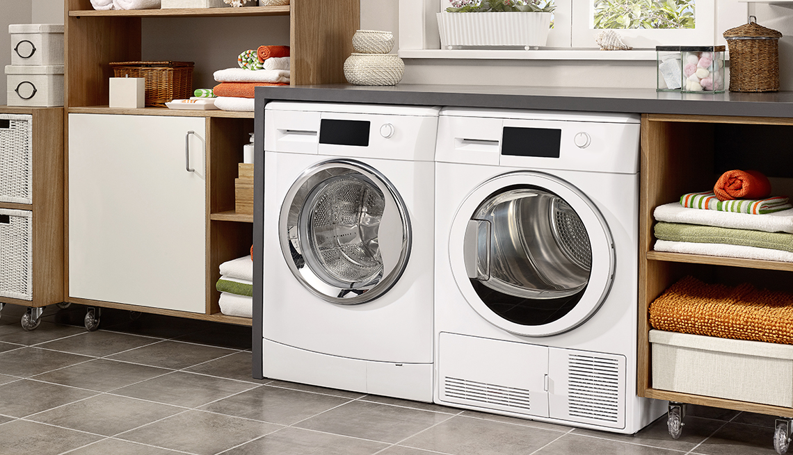 washing machine and dryer and shelves with folded towels in a laundry room in a house