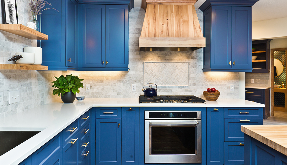 an immaculate kitchen with blue cabinets and white countertop