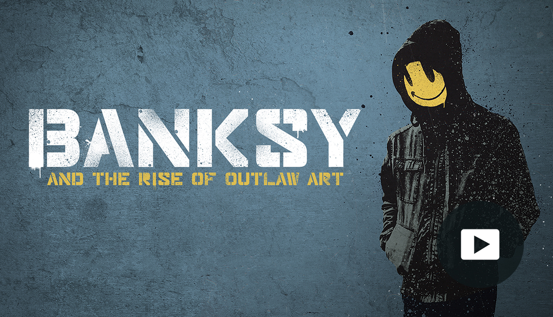 ‘Banksy and the Rise of Outlaw Art’ Documentary title in white and yellow with image of person in hooded jacket with yellow smiley face instead of real face, video play button in lower right corner.