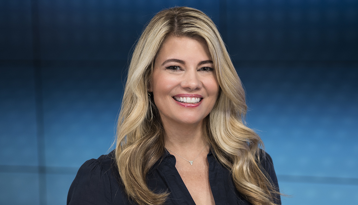 TV actress Lisa Whelchel poses in front of a blue background