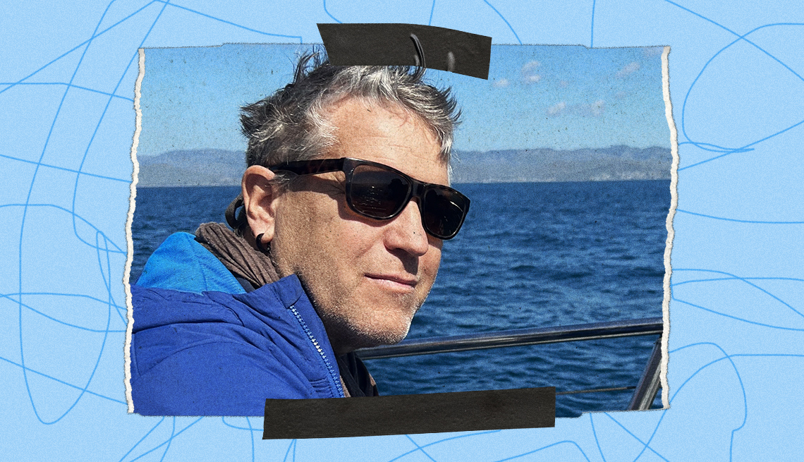 Black tape on top and bottom of a snapshot of Crai S. Bower wearing a winter coat while on a boat, blue water in the background. The photo is bordered by a blue background with squiggly lines.