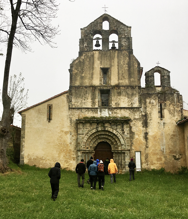 a tour group enters an old church in Spain