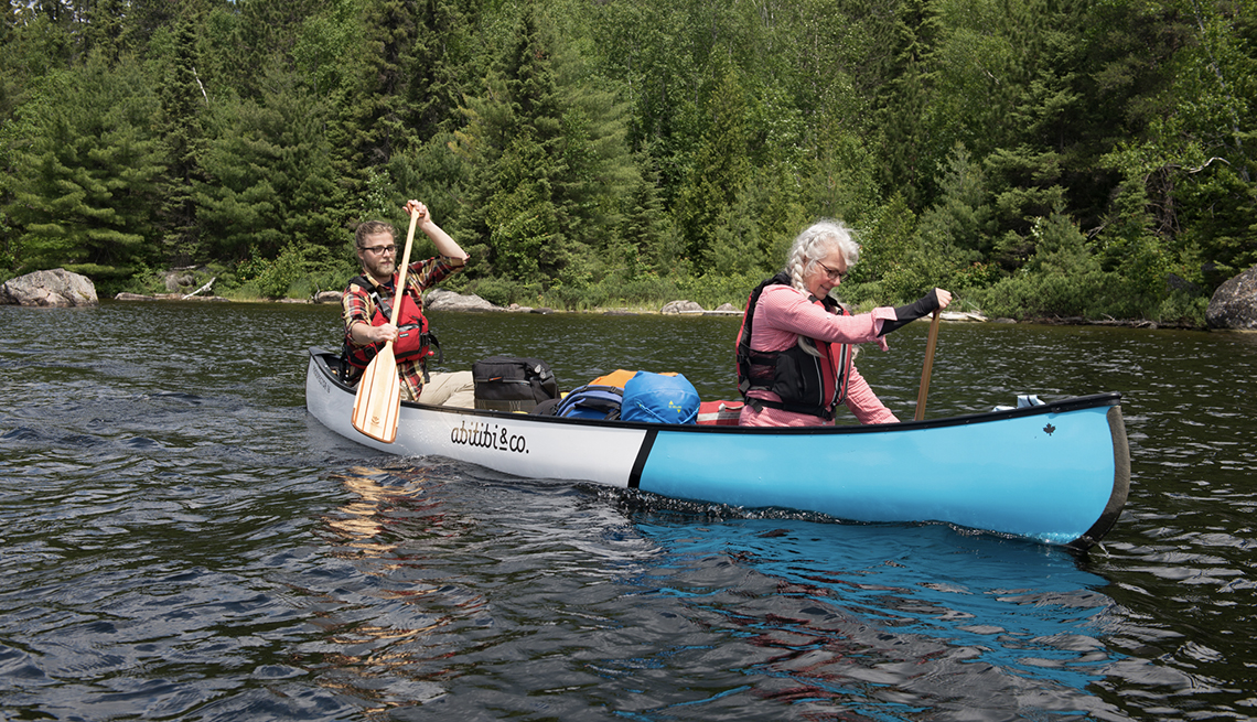 Two people paddle a canoe in Quebec