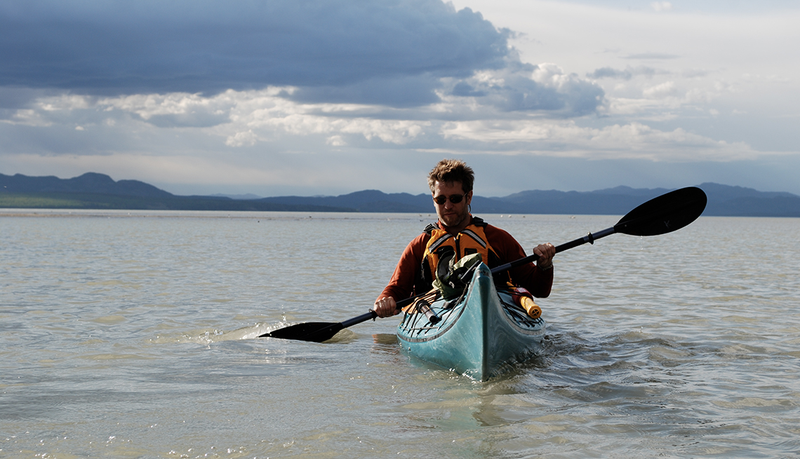 photo of a man kayaking in the Yukon  River