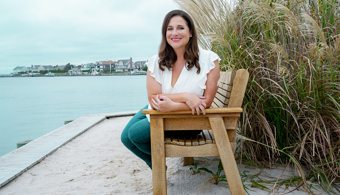 Author Jennifer Weiner sitting on an outdoor bench
