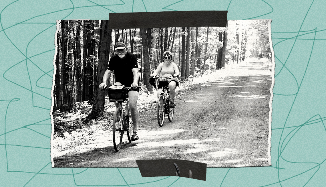teal border with squiggly lines surrounds a black and white image of a man and woman riding bicycles on black diamond trail lined with trees