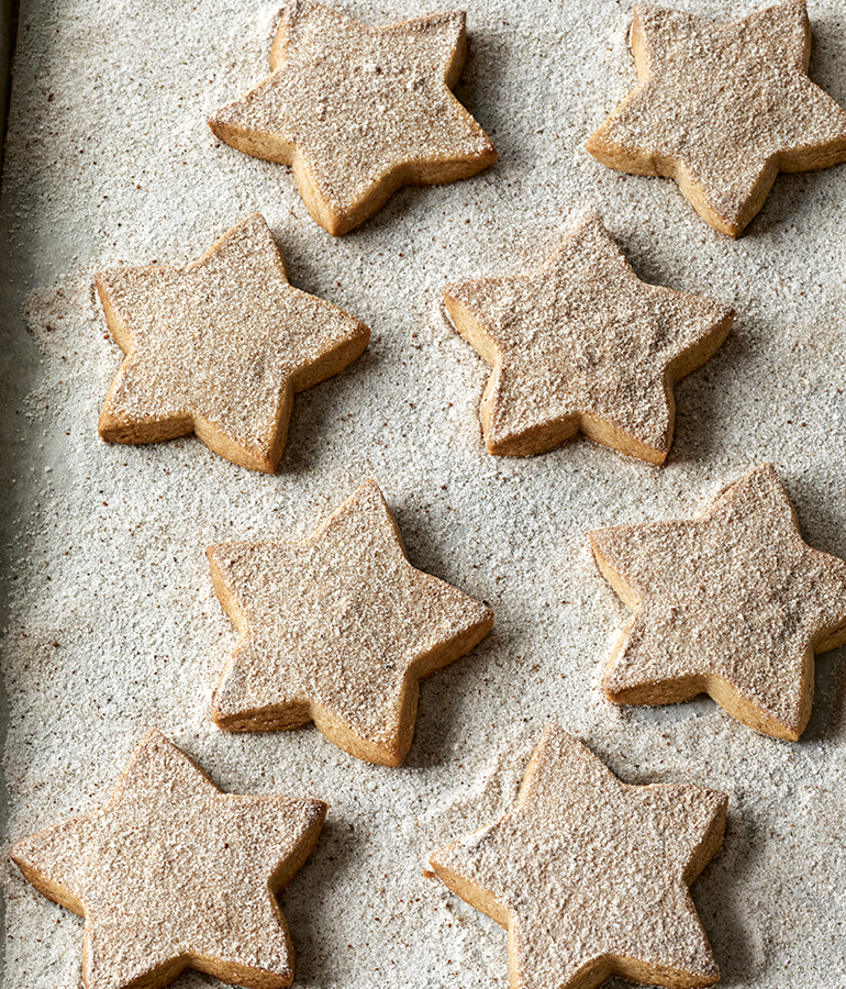 star shaped cookies on a surface of spices