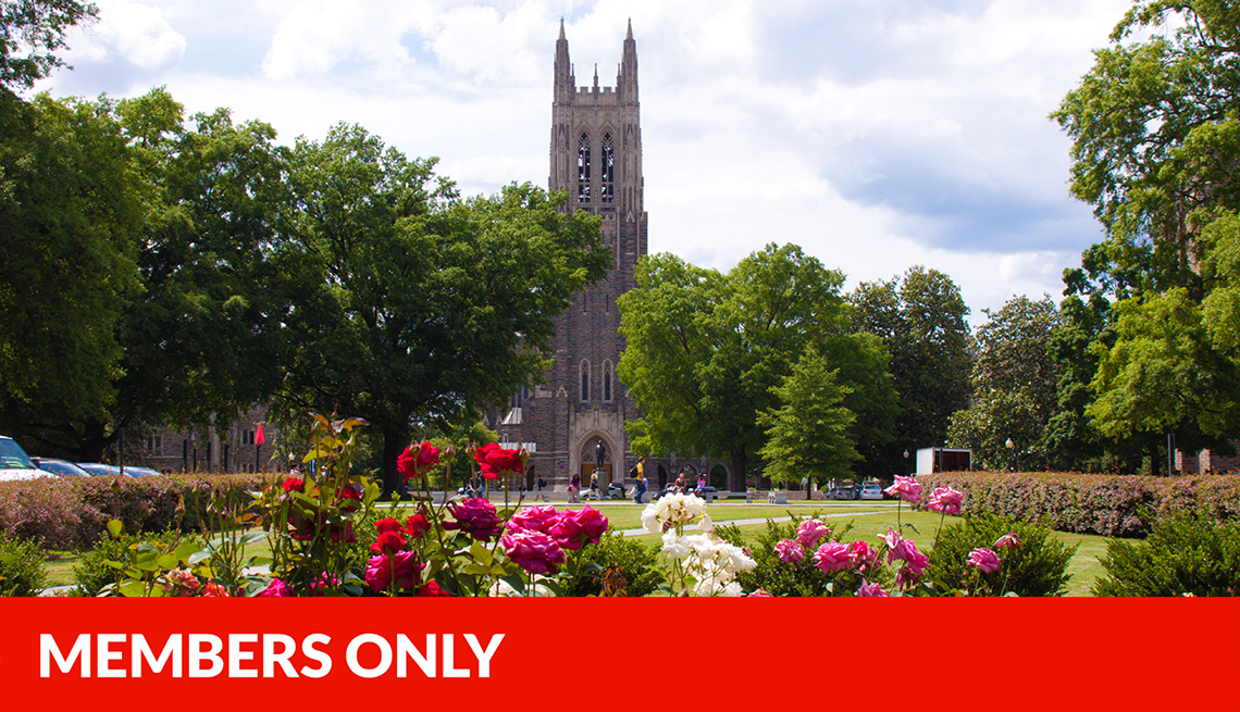 duke university chapel with trees surrounding it and flowers in foreground, red members only banner across bottom