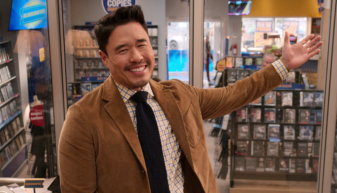 randall park as timmy in a video store in a still from the netflix show blockbuster
