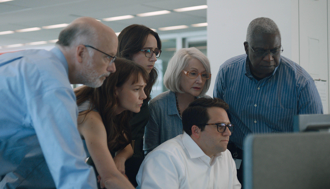 six people staring at a computer in a still from she said