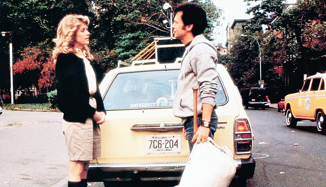 sally albright (meg ryan) and harry burns (billy crystal) stand talking behind yellow car on a city street in a scene from the movie when harry met sally