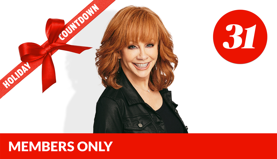 reba mcentire smiling in front of white background; number 31 in red circle in upper right corner; red ribbon with bow across left corner that says holiday countdown; red members only banner on bottom
