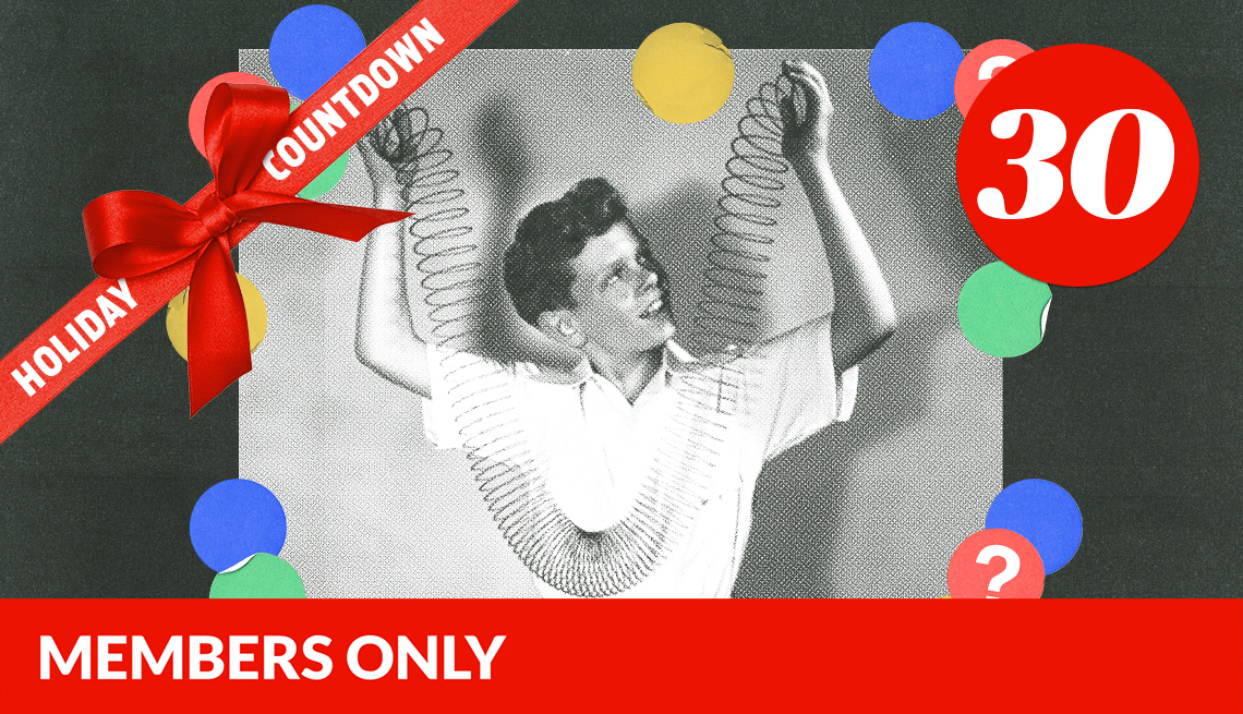black and white image of a boy holding both ends of slinky, surrounded by blue, red, green and yellow circles with question marks in them; black background; number 30 in red circle in upper right corner; red ribbon with bow across left corner that says holiday countdown; red members only banner on bottom