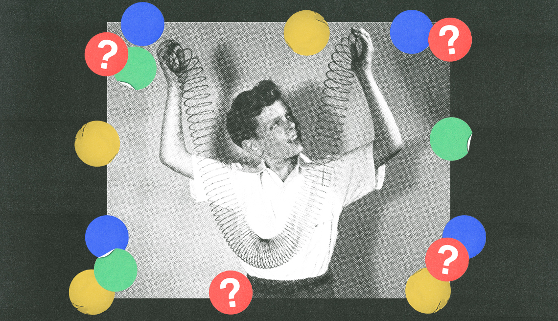 black and white image of a boy holding both ends of slinky, surrounded by blue, red, green and yellow circles with question marks in them; black background