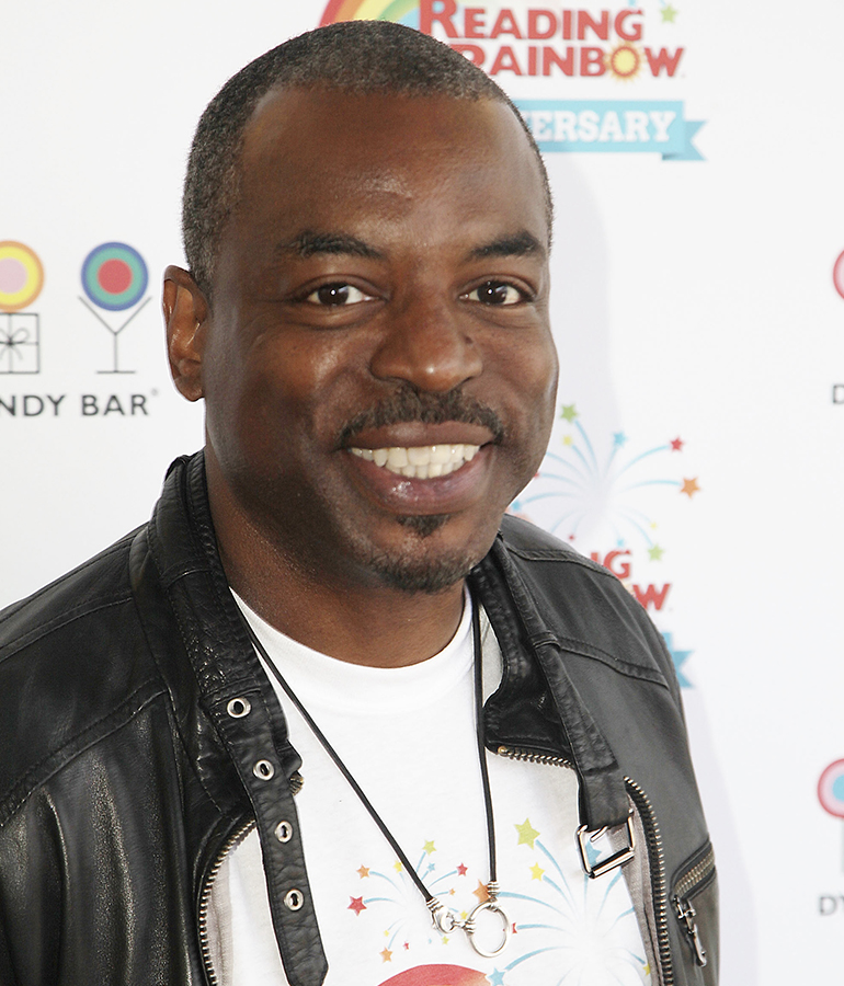 levar burton in front of backdrop that says reading rainbow