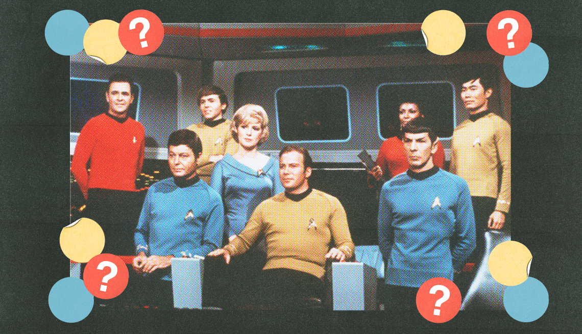 eight star trek cast members in still from the show; blue, yellow and red circles with question marks surround them