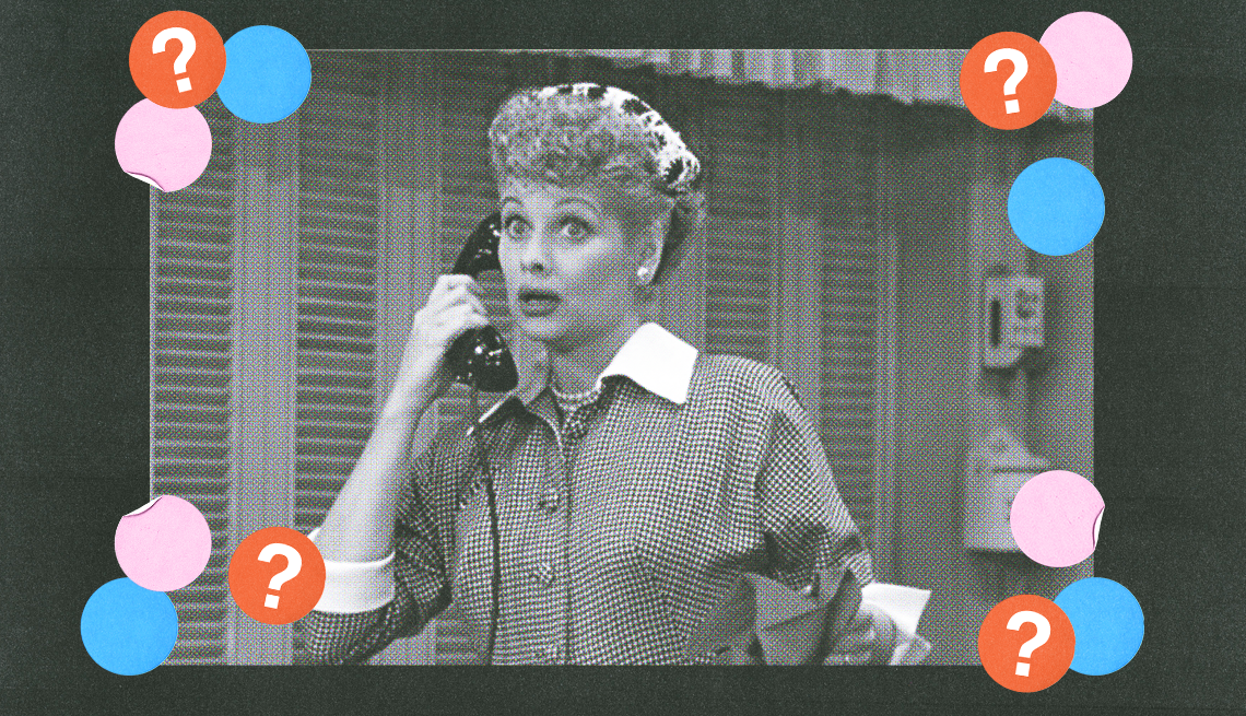 lucille ball as lucy ricardo holding telephone up to her ear with a surprised look on face in a still from i love lucy; pink, blue and red circles with question marks surround her