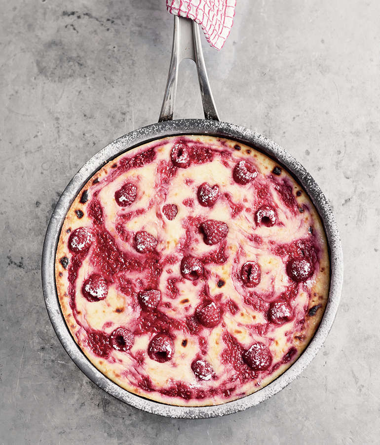 lemon cheesecake with raspberries in it in a pan