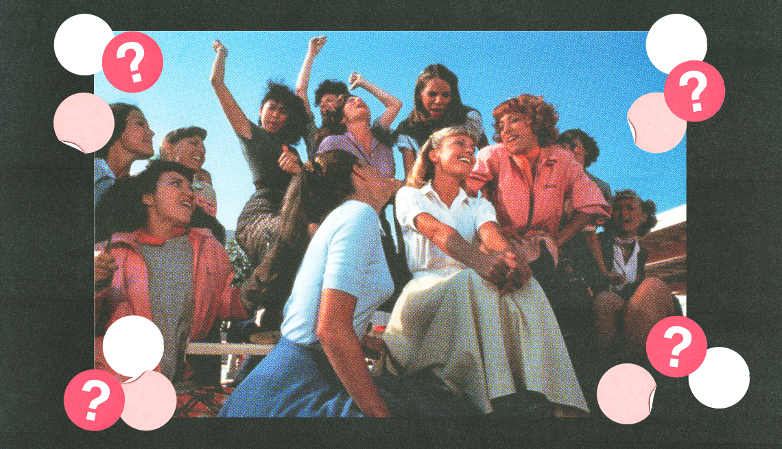 cast of grease under blue sky; white, light pink and red circles with question marks surround them