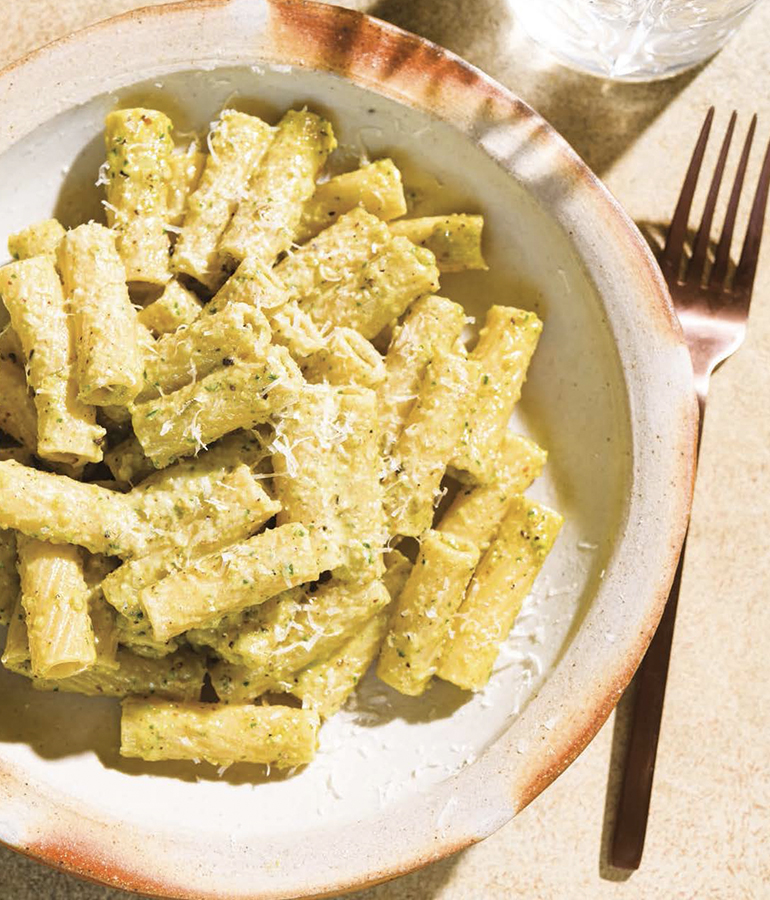 rigatoni with pistachio in bowl with fork next to it