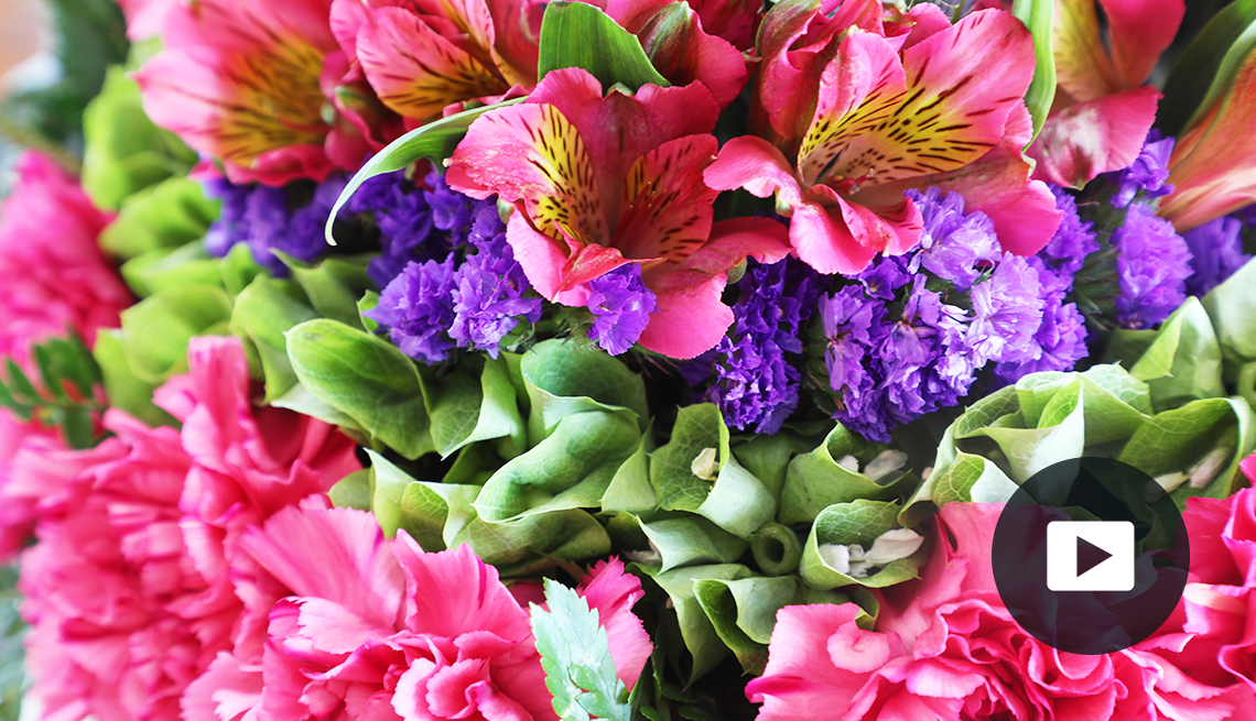 vibrant pink, purple and green flowers; play button in bottom right corner