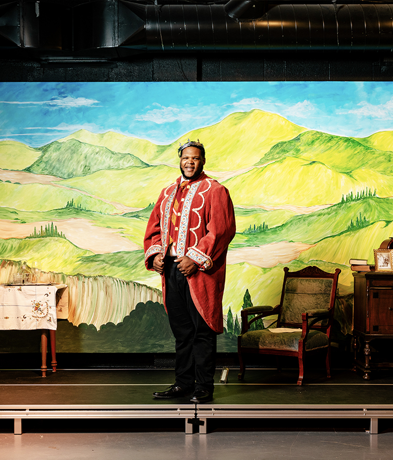 dressed in his don pedro costume, martel burton poses on the stage at the ghostlight theatre before a dress rehearsal of much ado about nothing