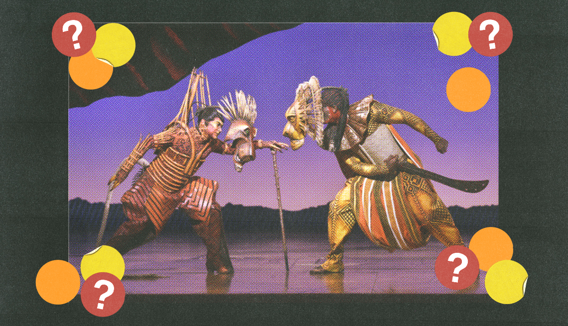 two people dressed as lions holding swords facing each other on a stage; yellow, orange and red circles with question marks surround them