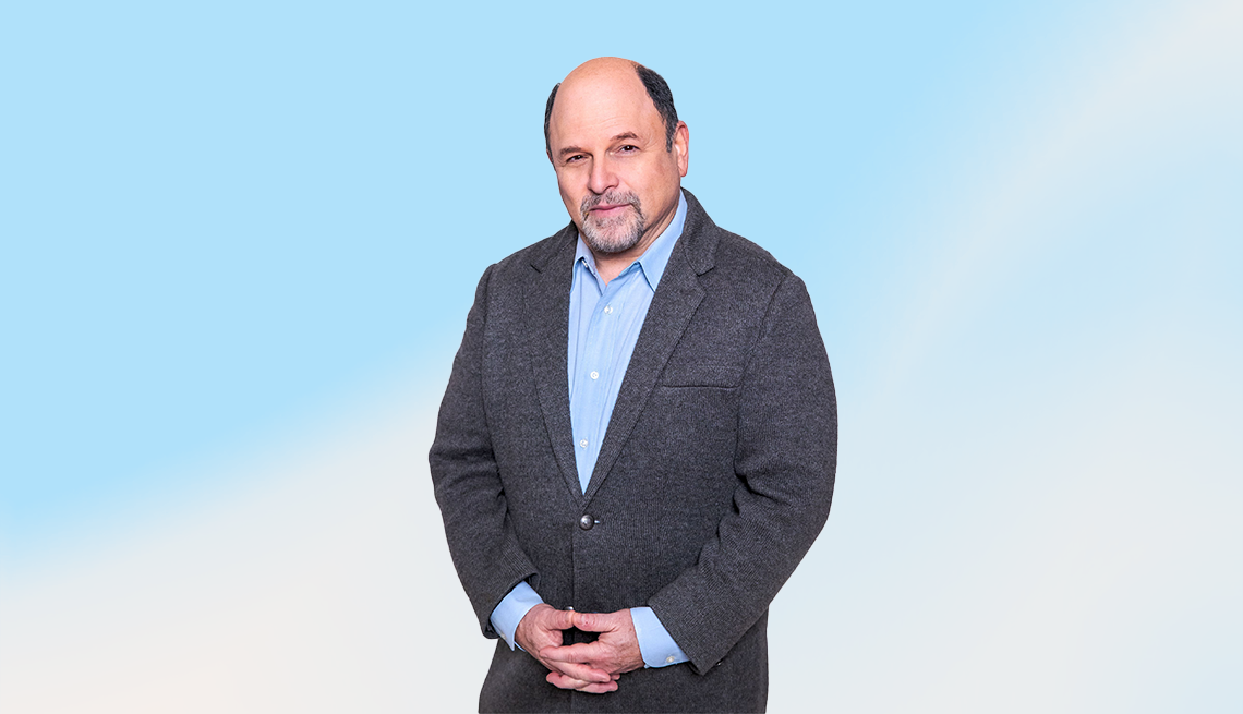 Jason Alexander against blue and white ombre background