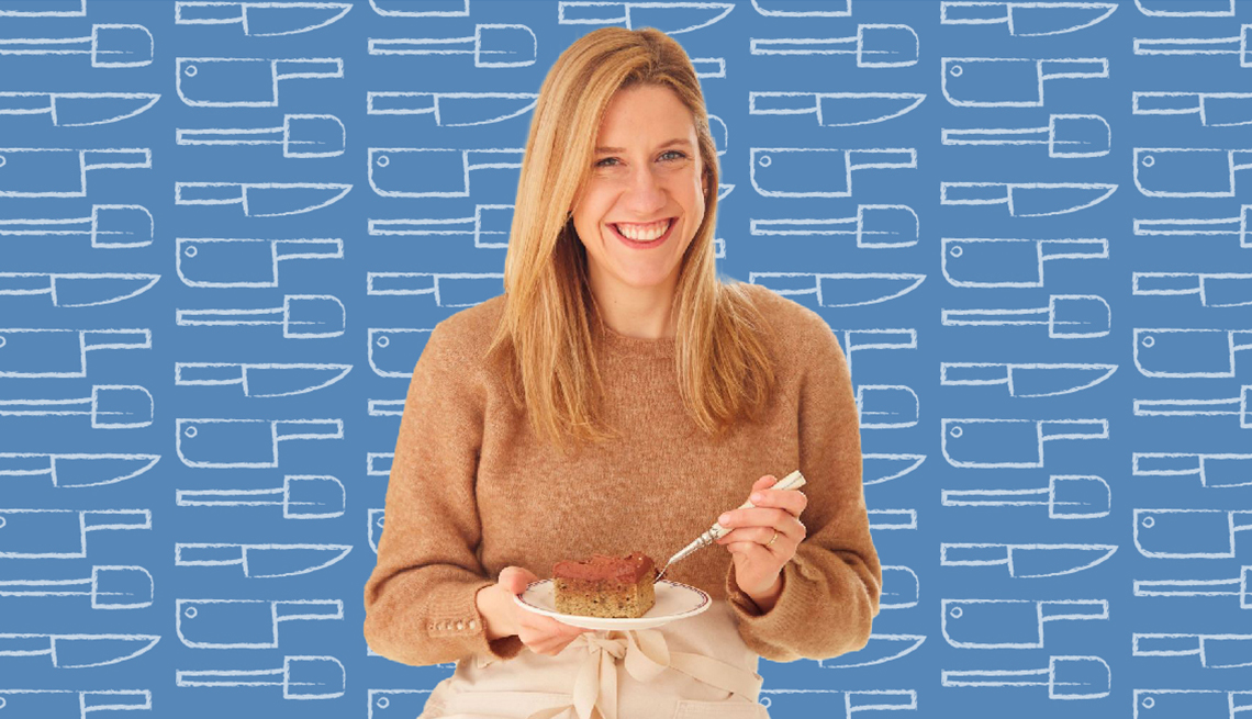 Lidey Heuck holding piece of cake on plate; blue background with outlines of kitchen utensils on it