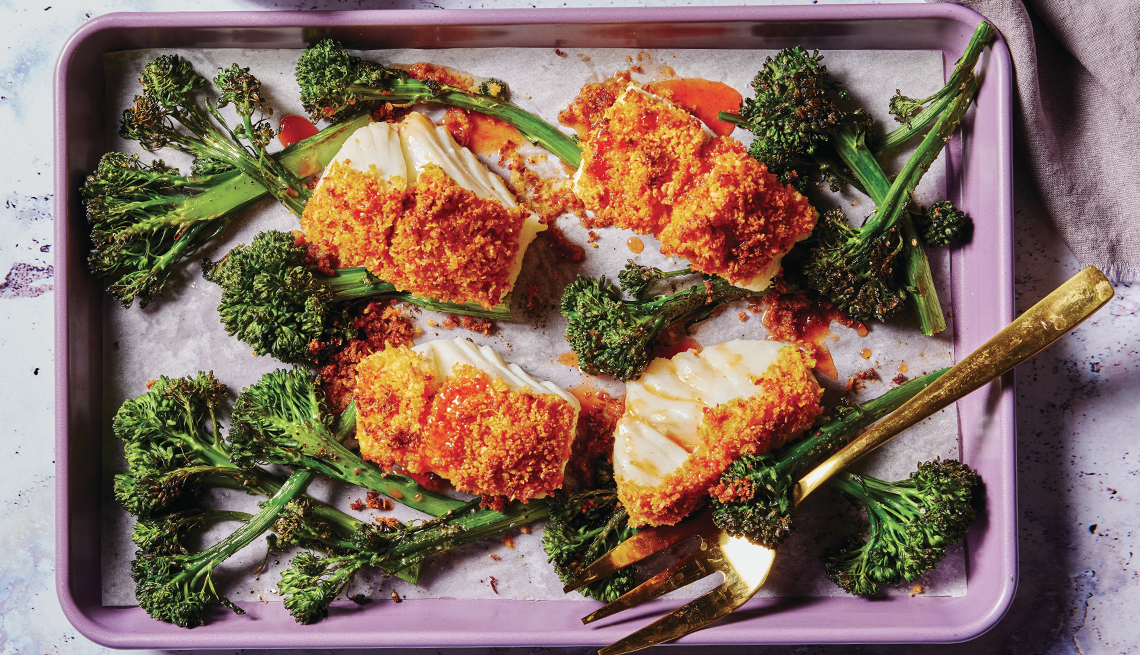 Coconut-Crusted Fish with Honey-Chili Drizzle on baking sheet