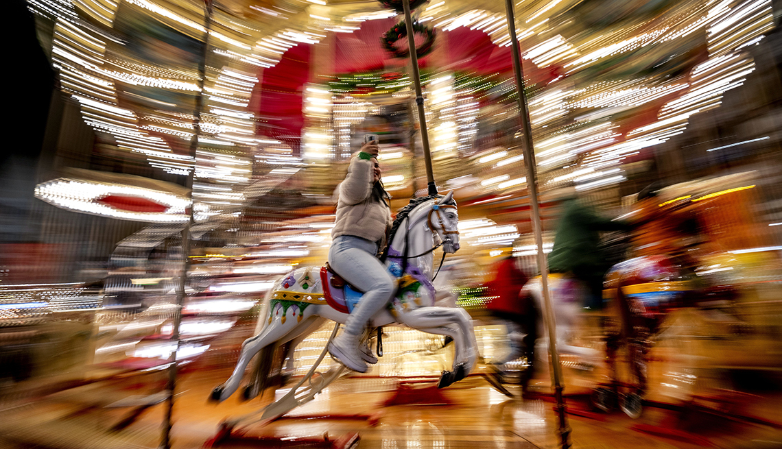 item 17 of Gallery image - long-exposure picture of girl taking a selfie while riding on a horse on a merry-go-round