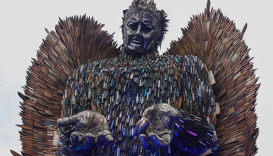 item 6 of Gallery image - thousands of blades are visible in the national monument against violence and aggression, also known as the knife angel, shown here from the waist up