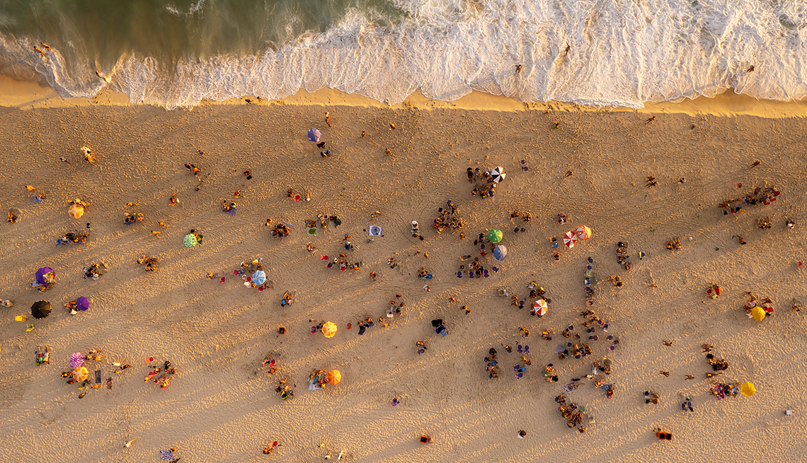 item 17 of Gallery image - aerial view of rio’s ipanema beach where waves are crashing at the shoreline and beachgoers are set up on the sand  