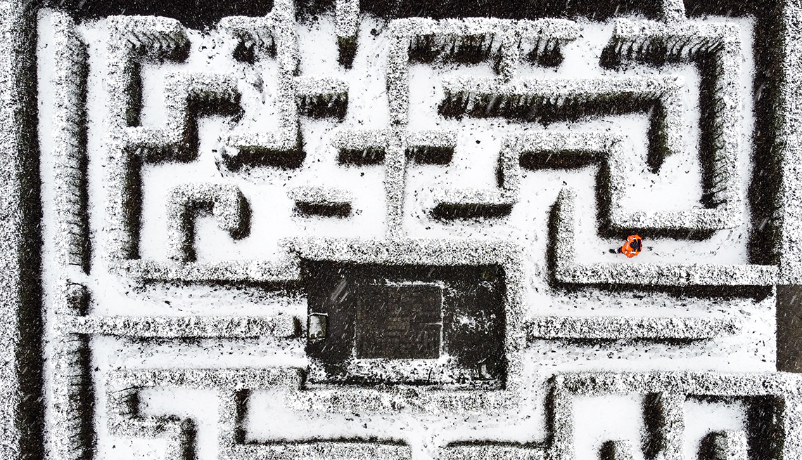 item 16 of Gallery image - aerial view of a snowy maze with a sole person walking through it