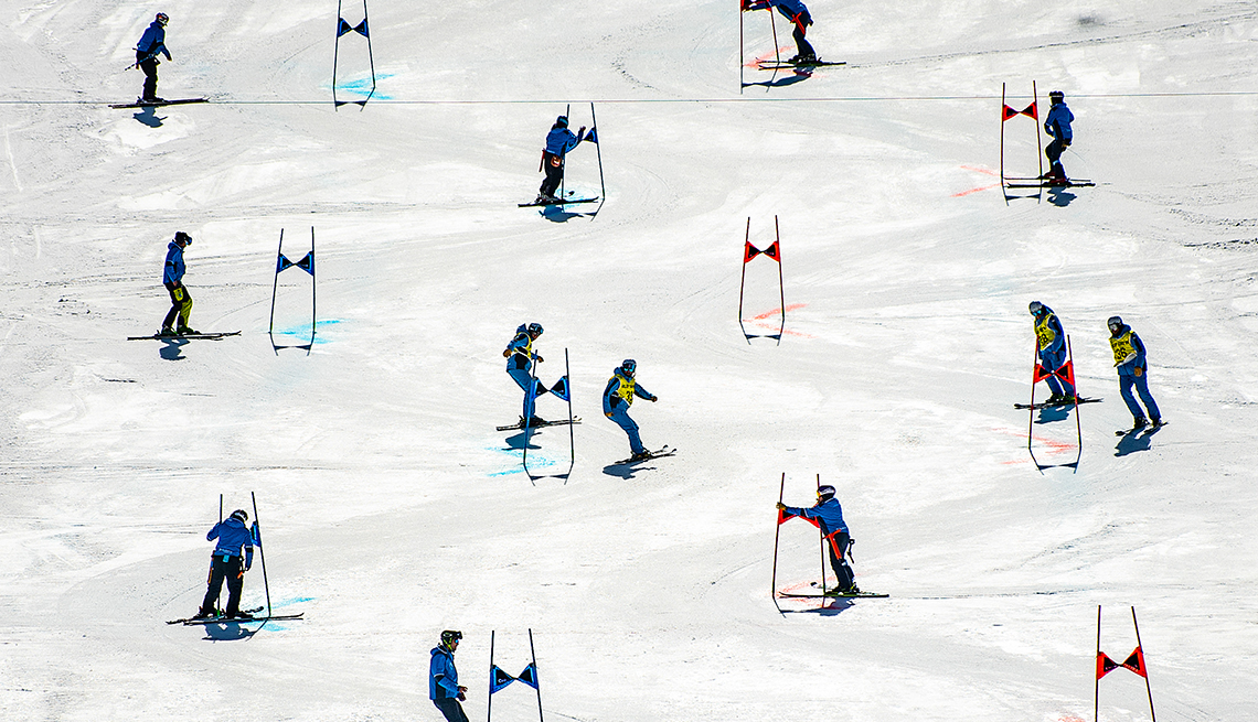 item 2 of Gallery image - about a dozen skiers set up a race course on a ski slope