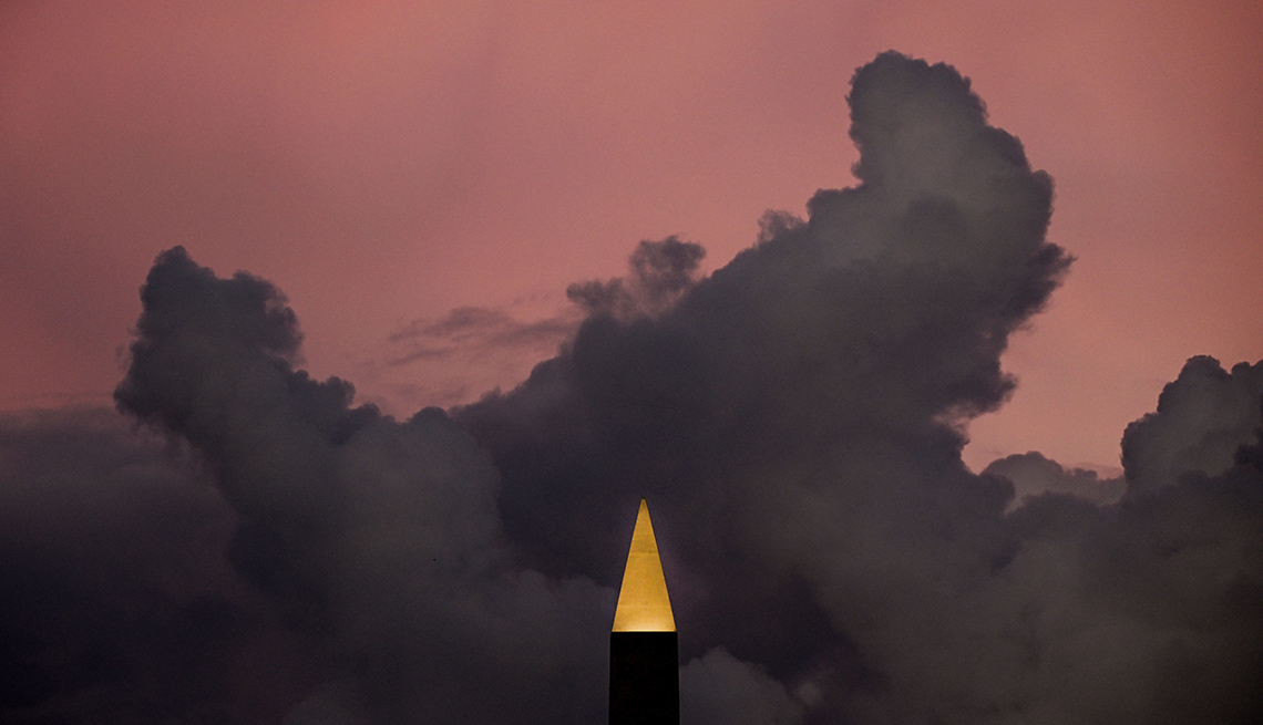 item 11 of Gallery image - dark clouds surround the luxor obelisk illuminated against a pink sky