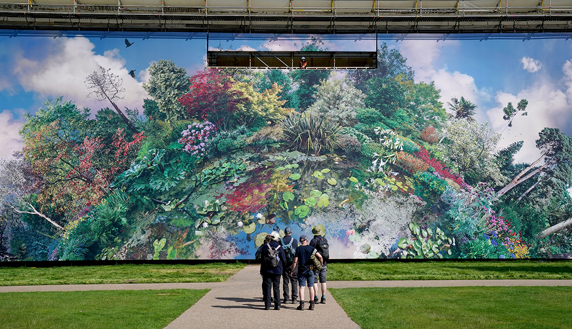 item 2 of Gallery image - a small group of visitors standing on a path view planet wakehurst, a massive art installation featuring a colorful photo montage of plant collections