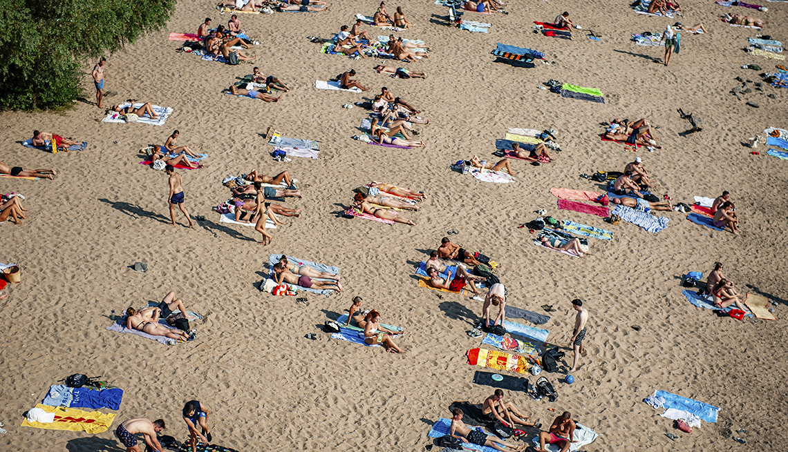 item 13 of Gallery image - People sunbathe on the banks of the Waal river in Nijmegen, Netherlands. 