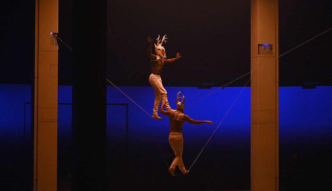 item 7 of Gallery image - Artists from Cirque du Soleil “ECHO” perform a double slackline routine.