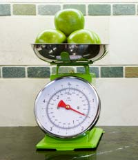 green apples on a scale