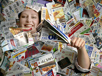 Janet Robinett, of Olathe, KS, pictured March 16, 2009 blanketed in coupons, teaches a BeCentsable workshop on frugal living.