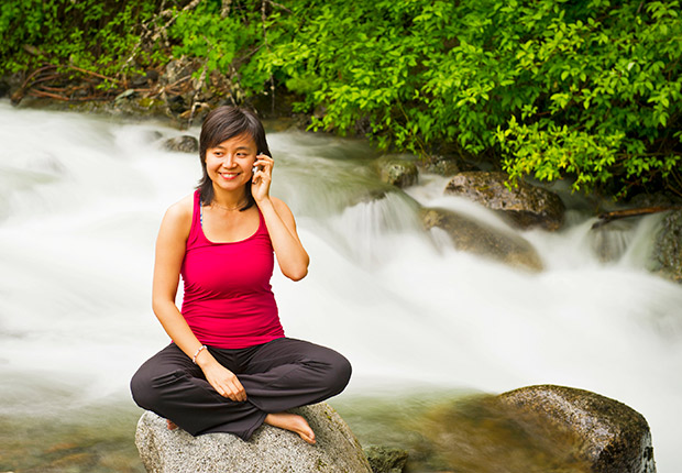 Be calm. Woman on phone doing yoga