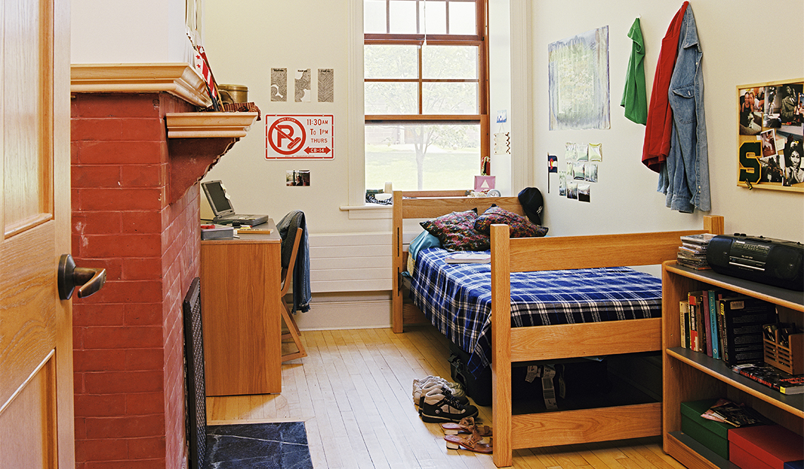 item 9 of Gallery image - Dorm room with a fireplace on the left side and a bed on the right side